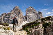 © erika8213 - Stunning view of a tourist enjoying the view of the Tre Cime Di Lavaredo, Dolomites, Italy.