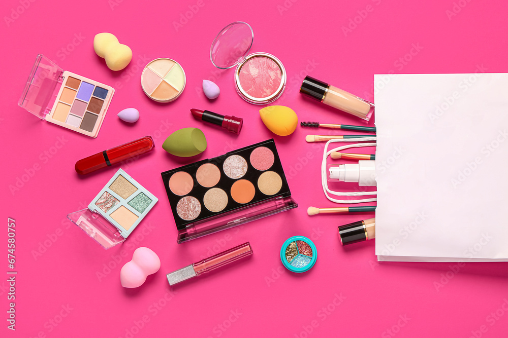 Shopping bag with makeup cosmetics on pink background