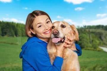 Canvas Print - a young happy woman plays with a dog