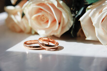 Couple Of Gold Wedding Rings With Flowers