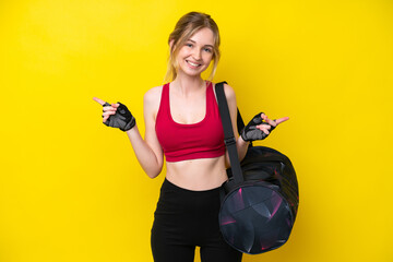 Sticker - Young sport caucasian woman with sport bag isolated background pointing finger to the laterals and happy