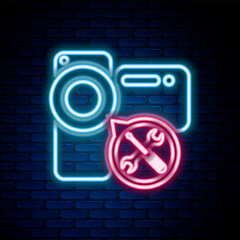 Poster - Glowing neon line Video camera with screwdriver and wrench icon isolated on brick wall background. Adjusting, service, setting, maintenance, repair, fixing. Colorful outline concept. Vector