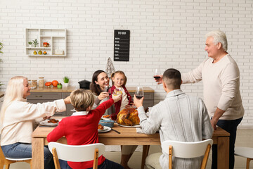 Wall Mural - Happy family having dinner at festive table on Thanksgiving Day