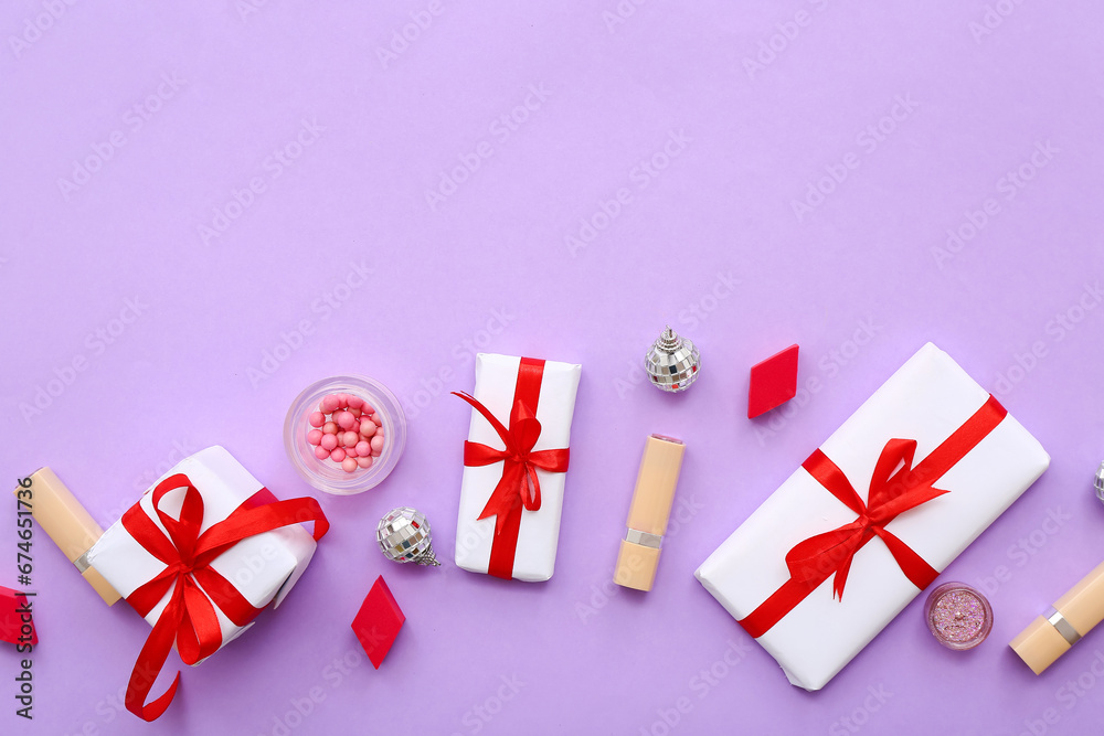 Different decorative cosmetics with Christmas balls and gift boxes on lilac background