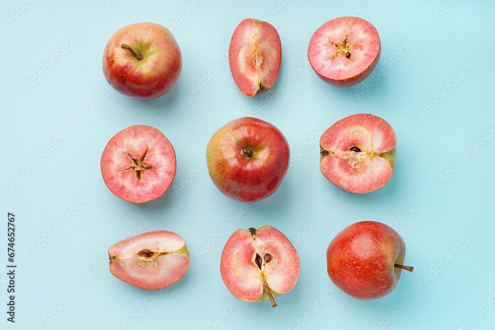 Sweet pink apples on blue background