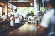 © chartchai - Blurred coffee shop or cafe restaurant The background of the restaurant was blurry and there were some people, a chef and a waiter working.by Generative AI