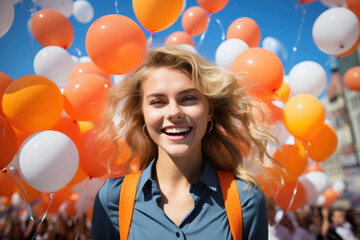 Happy Dutch girl with orange ballons in Netherlands Kingdom Day