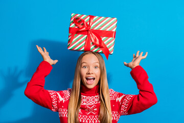 Sticker - Photo of funky nice impressed schoolgirl with blond hair dressed red sweater hold gift box on had isolated on blue color background