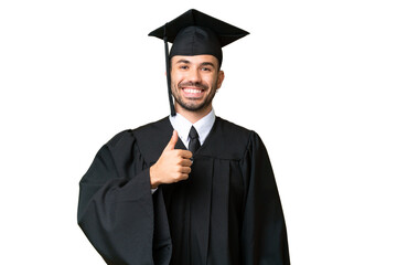 Wall Mural - Young university graduate man over isolated chroma key background giving a thumbs up gesture