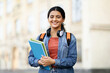 © Prostock-studio - Indian woman student wearing casual outfit with backpack and notepads