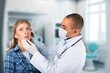© BillionPhotos.com - Young doctor listen to patient at clinic meeting, AI generated image