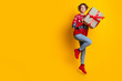 © deagreez - Full body photo of satisfied cute woman with stylish hair wear sweater hold present box jumping isolated on yellow color background