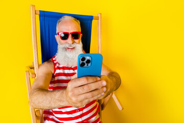 Sticker - Close up portrait of carefree resort party pensioner grandfather wear sunglasses blogging photographing isolated on yellow color background