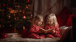 © MoonS  - Two kids reading a book under decorate Christmas tree. AI generative.