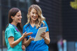© Dragana Gordic - Nurses walking and talking. Diversity workers, smile and happy medical healthcare teamwork on treatment collaboration. Shot of two young nurses talking outside