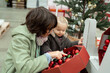 © Anna - Teenager boy with little toddler girl looking at Christmas decorations in a large supermarket. Children waiting for New Year, preparation for winter holidays. High quality photo