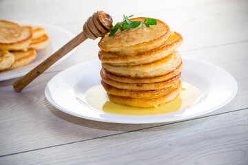 Wall Mural - cooked sweet pancakes with honey in a plate