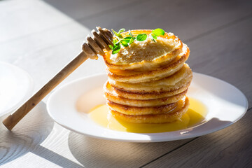 Wall Mural - cooked sweet pancakes with honey in a plate