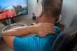 © Nenad - Feeling exhausted. Frustrated  handsome gamer man looking exhausted while sitting at his working place while live stream. Stress, burnout and neck pain  man with headache, anxiety and depression