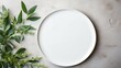 On a light surface, an oval ceramic plate with a laconic decor, green leaves, ceramic studio, copyspace, hobby, handmade, top view, table texture, glossy, clay plate, white, stalk, minimalism, dirty