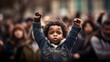 A black child raising a powerful fist. Symbolizing the spirit of protest