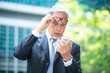 © Minerva Studio - Portrait of an upset senior manager using his smartphone