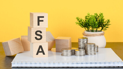 Poster - FSA - text on wood cubes stack, yellow background