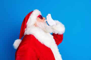 Wall Mural - Photo portrait of mature pensioner man shout announce sales dressed stylish santa claus costume coat isolated on blue color background