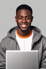 Poster - A man wearing a hoodie sitting in front of a laptop