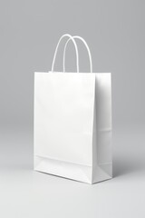 Wall Mural - A white paper bag is placed on a plain gray background. This versatile image can be used for various purposes