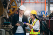 © NewSaetiew - Industrial worker inspecting machine at factory machines. Technician working in the metal sheet company. Foreman checking Material or Machine.