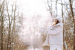 © maxbelchenko - Winter walk. A smiling woman in winter clothes walks through a snowy forest on a sunny frosty day. Concept of walking, travel.