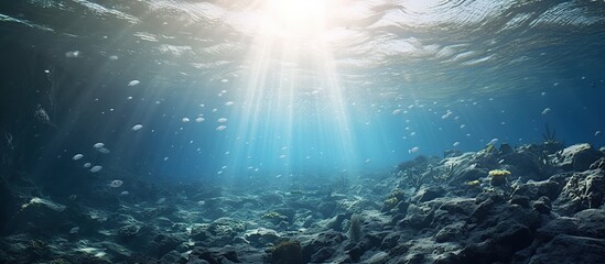 Deep ocean full of life. Underwater coral reef with fish and rays of sun through water surface