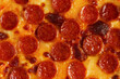 Close-up of the surface of pepperoni pizza with sausages and mozzarella