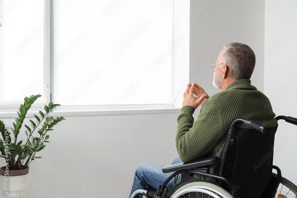 Senior man in wheelchair at home