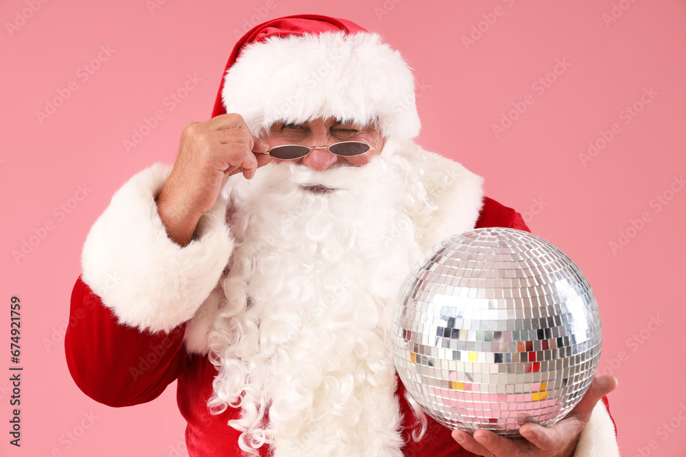Cool Santa Claus with disco ball on pink background, closeup