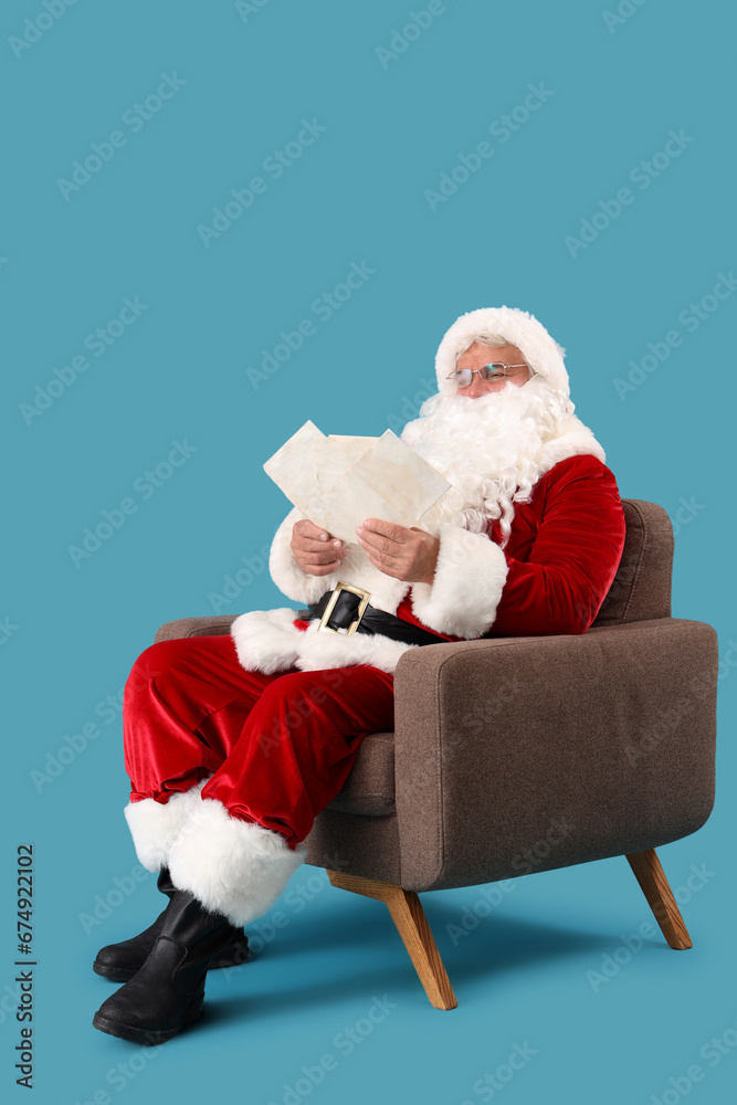 Santa Claus with letters sitting in armchair on blue background