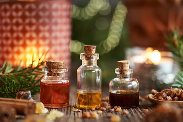 Wall Mural - Christmas selection of essential oils with frankincense, myrrh, cinnamon and spruce