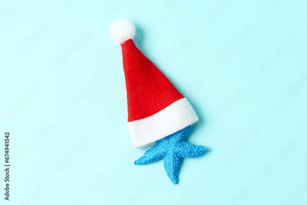 Starfish with Santa hat on blue background
