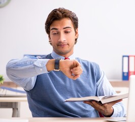 Wall Mural - Young handsome employee working in the office