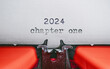 Old Typewriter with following text on paper - 2024 Chapter one. new years concept