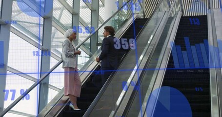 Canvas Print - Animation of data processing against diverse man and woman discussing on escalator at office