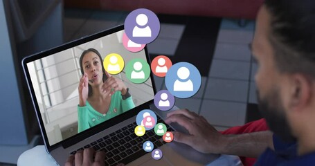 Poster - Animation of profile icons floating against rear view of biracial man having a video call on laptop