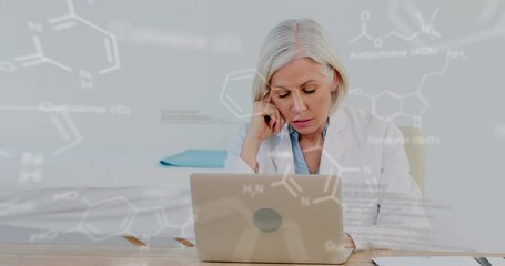 Canvas Print - Animation of medical data processing over stressed caucasian female doctor using laptop at hospital