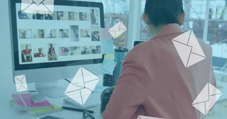 Aufkleber - Animation of envelopes over biracial female photographer looking at camera while working in office