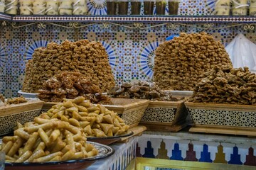 Plate full of delicious honey-glazed fried pastry sweet on display in a pastry shop in Morocco