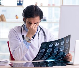 Young handsome male radiologist in front of whiteboard