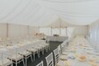 Beautiful and romantic interior view of a wedding reception tent.