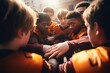 High school American football team with teenage boys holding hands in a huddle