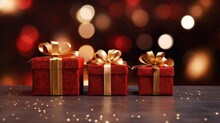 Golden Gift Presents On A Light Dark Red Background With Colorful Bokeh And Stars Glittering